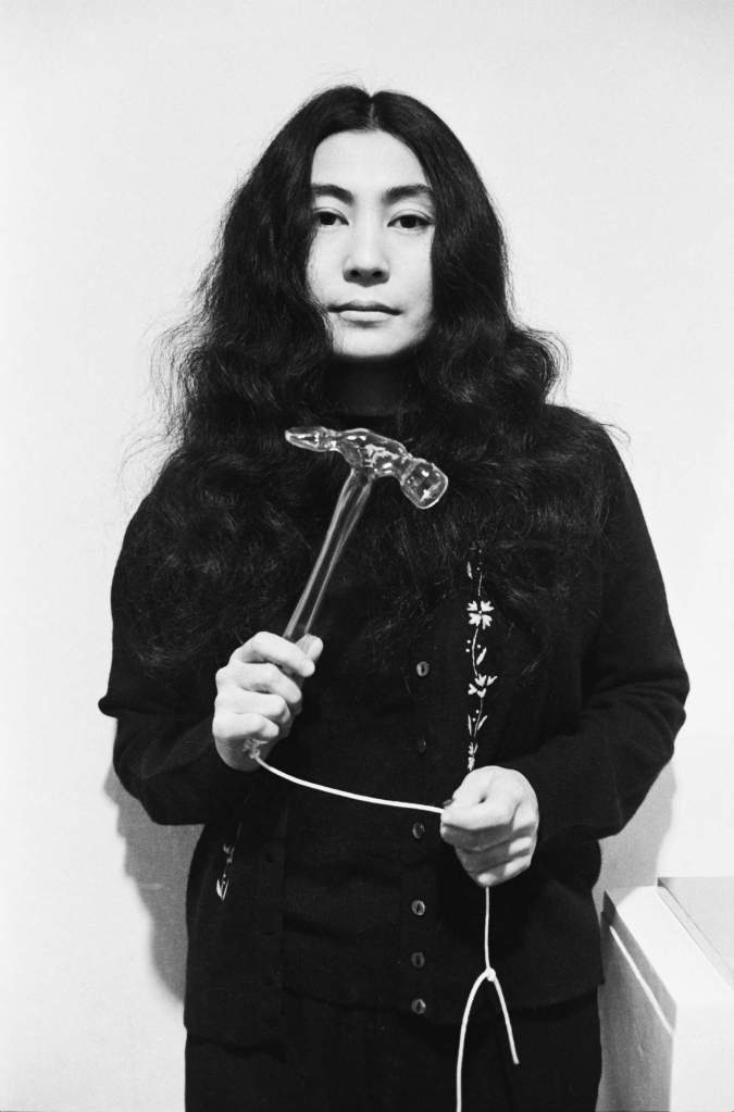 Yoko Ono with Glass Hammer 1967 from HALF-A-WIND SHOW, Lisson Gallery, London, 1967 —  Ph © Clay Perry / Artwork © Yoko Ono